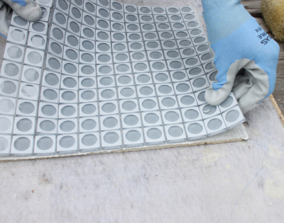 laying glass tile sheet on thinset